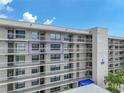 Close up of condo balcony, showing railing and windows, along with the building architecture at 1332 Pasadena S Ave # 503, South Pasadena, FL 33707