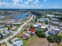 Aerial view of a community with a lake, and trees highlighting the property's desirable location at 1349 New Bedford Dr # 6, Sun City Center, FL 33573