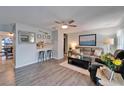 Comfortable living room featuring modern flooring, stylish furnishings, and a convenient breakfast bar at 1349 New Bedford Dr # 6, Sun City Center, FL 33573
