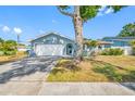 Charming single Gathering home with a two-car garage and mature tree in front yard at 14884 Cromwell Dr, Clearwater, FL 33764