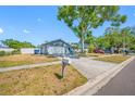 The home has an attached two car garage and driveway; the front yard needs some TLC at 14884 Cromwell Dr, Clearwater, FL 33764