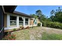 Backyard view with three large windows providing an abundance of light at 150 Tompkins St, Port Charlotte, FL 33954
