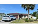 Inviting single-Gathering home with a well-manicured lawn and mature palm tree at 150 Tompkins St, Port Charlotte, FL 33954