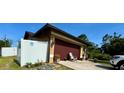 Attached garage and fenced yard in this single-Gathering home at 150 Tompkins St, Port Charlotte, FL 33954