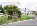 Exterior view of the Belleair Oaks Condominiums with a sign at 1975 W Bay Dr # 301, Largo, FL 33770