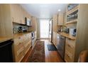 Clean kitchen featuring wooden cabinets, stainless steel appliances, and hardwood floors at 1975 W Bay Dr # 301, Largo, FL 33770