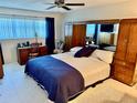 Comfortable main bedroom with a large bed, ample storage, and a cozy workspace at 2254 Norwegian Dr # 46, Clearwater, FL 33763