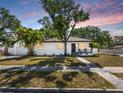 Charming home boasts mature trees and a well-kept lawn, enhancing its curb appeal at 2322 21St S St, St Petersburg, FL 33712