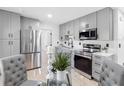 Modern kitchen features gray cabinetry, stainless steel appliances, and a stylish breakfast nook at 2322 21St S St, St Petersburg, FL 33712