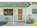 Close-up of the charming front door with decorative details and a welcoming entrance at 2410 E Bougainvillea Ave, Tampa, FL 33612