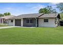 Lovely one-story home with a garage, screened porch and beautiful lawn at 2444 Magellan Ave, Spring Hill, FL 34608