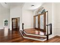 Grand foyer featuring beautiful hardwood floors, elegant staircase, and double-door entrance at 2513 Buckhorn Run Dr, Valrico, FL 33596