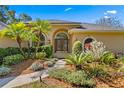 Charming home featuring a beautifully landscaped front yard and inviting double door entrance at 2513 Buckhorn Run Dr, Valrico, FL 33596
