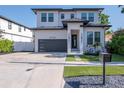 Charming two-story home with a modern design, featuring a black garage door at 2707 W Fig St, Tampa, FL 33609