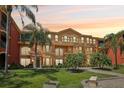 Exterior angle view of a well-maintained lawn and appealing condo complex at 2757 Via Cipriani # 1121B, Clearwater, FL 33764