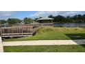 Community dock with shaded gazebo perfect for fishing, relaxing, and enjoying waterfront views at 4127 Dolphin Dr # 4127, Tampa, FL 33617