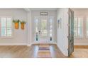 Bright foyer featuring wood floors, decorative rug, and a view of the front door with sidelights at 4710 W El Prado Blvd, Tampa, FL 33629