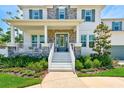 Inviting front porch with stone accents, white railings, and a beautifully landscaped entrance at 4710 W El Prado Blvd, Tampa, FL 33629