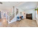 Open-concept living room with hardwood floors, staircase, and views to other rooms at 4710 W El Prado Blvd, Tampa, FL 33629
