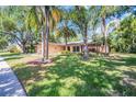Serene single-story home with mature trees providing ample shade to the sprawling front yard at 495 Palmdale Dr, Oldsmar, FL 34677