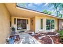 Elegant front entrance featuring a double-door entry, detailed trim, and lush landscaping at 495 Palmdale Dr, Oldsmar, FL 34677