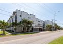 Contemporary apartment complex featuring modern architecture with well-manicured landscaping and palm trees at 5008 S Macdill Ave # 10, Tampa, FL 33611