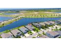 Aerial view of lakefront home with lush landscaping, perfect for serene living at 5814 Silver Sun Dr, Apollo Beach, FL 33572
