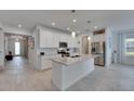 Well-lit kitchen with stainless steel appliances, granite countertops and large center island at 5814 Silver Sun Dr, Apollo Beach, FL 33572