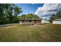 Single-story home with a well-kept lawn, and a neatly paved front entrance at 6423 Bass Rd, Weeki Wachee, FL 34607