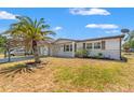 A single-story home with mature palm tree and a convenient carport at 6424 Ponder Dr, Port Richey, FL 34668