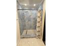 Updated bathroom featuring a stand up shower with rainfall shower head and designer tile at 7017 Baywood Dr, Tampa, FL 33637