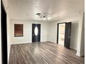 Open-concept living area with hardwood floors, fresh paint, and modern ceiling fan at 7017 Baywood Dr, Tampa, FL 33637