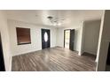 Bright living room featuring new flooring, a modern light fixture, and updated trim work at 7017 Baywood Dr, Tampa, FL 33637