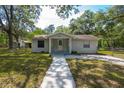 Charming single-story home with a well-maintained lawn, inviting walkway, and quaint front porch at 7211 & 0 Sunnyside Dr, Brooksville, FL 34601