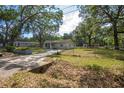 Single story home featuring a well-manicured lawn and mature trees in a desirable location at 7211 & 0 Sunnyside Dr, Brooksville, FL 34601