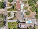 Aerial view showcasing the property's layout, including the home, driveway, and landscaping and pool at 936 Alcazar Way S, St Petersburg, FL 33705