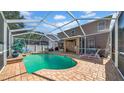 Covered pool area with brick deck, fenced in yard, and outdoor seating at 10505 Boyette Creek Blvd, Riverview, FL 33569
