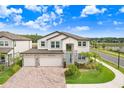 Charming two-story home boasts a three-car garage, beautiful landscaping, and serene neighborhood views in a sunny locale at 10901 Sundrift Dr, Tampa, FL 33647