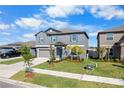 Two-story home with a well-manicured lawn, tidy flower beds, and a two-car garage at 11079 Linden Depot Rd, San Antonio, FL 33576
