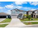 Two-story home with a well-manicured lawn, tidy flower beds, and a two-car garage at 11079 Linden Depot Rd, San Antonio, FL 33576