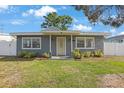 Charming single-story home with a well-maintained lawn and front porch at 11104 Hackney Dr, Riverview, FL 33578