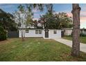 Charming single-story home featuring a freshly painted exterior, updated windows, and a well-manicured front yard at 11747 104Th N St, Largo, FL 33773