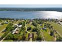 Aerial view of property showcasing the estate, landscaping, and water views at 11865 Fort King Hwy, Thonotosassa, FL 33592