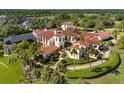 Expansive estate home with a red tile roof, sprawling lawns and mature trees at 11865 Fort King Hwy, Thonotosassa, FL 33592
