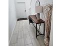 A bright entryway featuring light tile floors and a decorative console table at 12537 Timber Moss Ln, Riverview, FL 33579