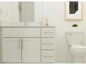 Modern bathroom vanity with white cabinets, sleek hardware, and a stylish countertop, with a toilet to the right at 12624 Aura Moonlight Ter, Parrish, FL 34219