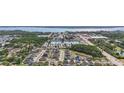 Scenic aerial view of a vibrant community with lush landscaping, serene ponds, and convenient access to nearby amenities at 1432 Gopher Loop, Tarpon Springs, FL 34689