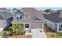 Charming two-story home with a well-manicured lawn and a two-car garage, perfect for suburban living at 1432 Gopher Loop, Tarpon Springs, FL 34689