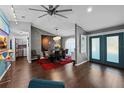 Modern dining room with stylish decor and wood floors leading to french doors at 14702 Dartmoor Ln, Tampa, FL 33624