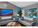 Cozy living room featuring a large TV and view of the screened-in pool area at 14702 Dartmoor Ln, Tampa, FL 33624